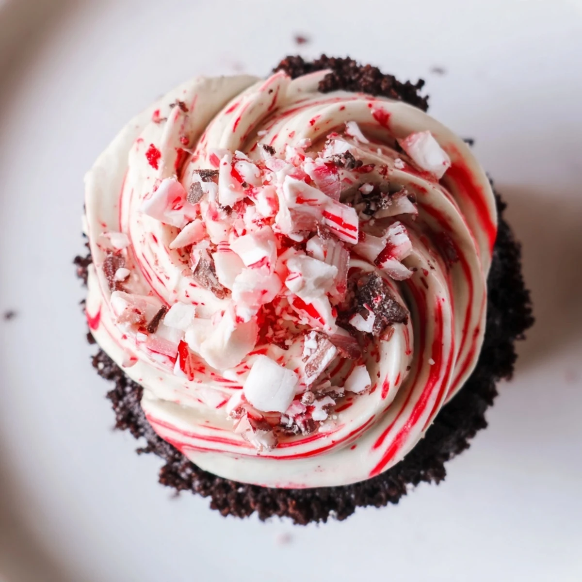 Freshly baked Chocolate Peppermint Swirl Cupcakes on a cooling rack with piped frosting, ready to serve with hot cocoa.