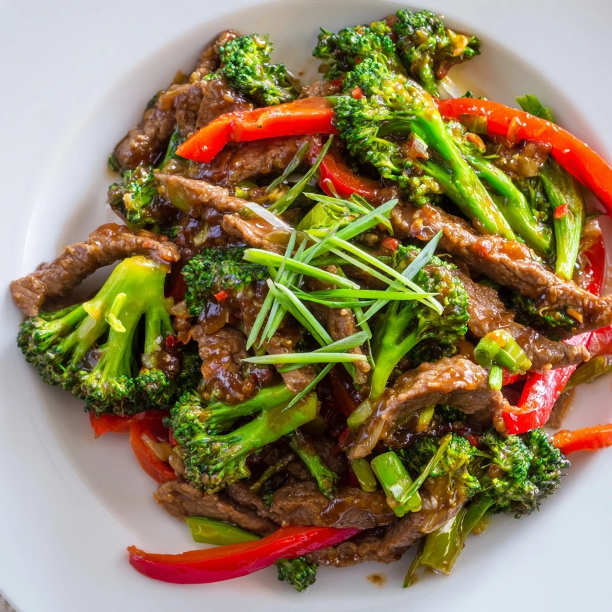 Tender beef strips and crisp broccoli florets glisten with a bold, spicy sauce in a hot wok.