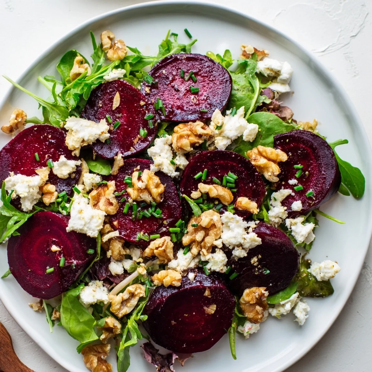 Vibrant roasted beet and goat cheese salad with toasted walnuts on mixed greens, finished with a zesty balsamic vinaigrette.