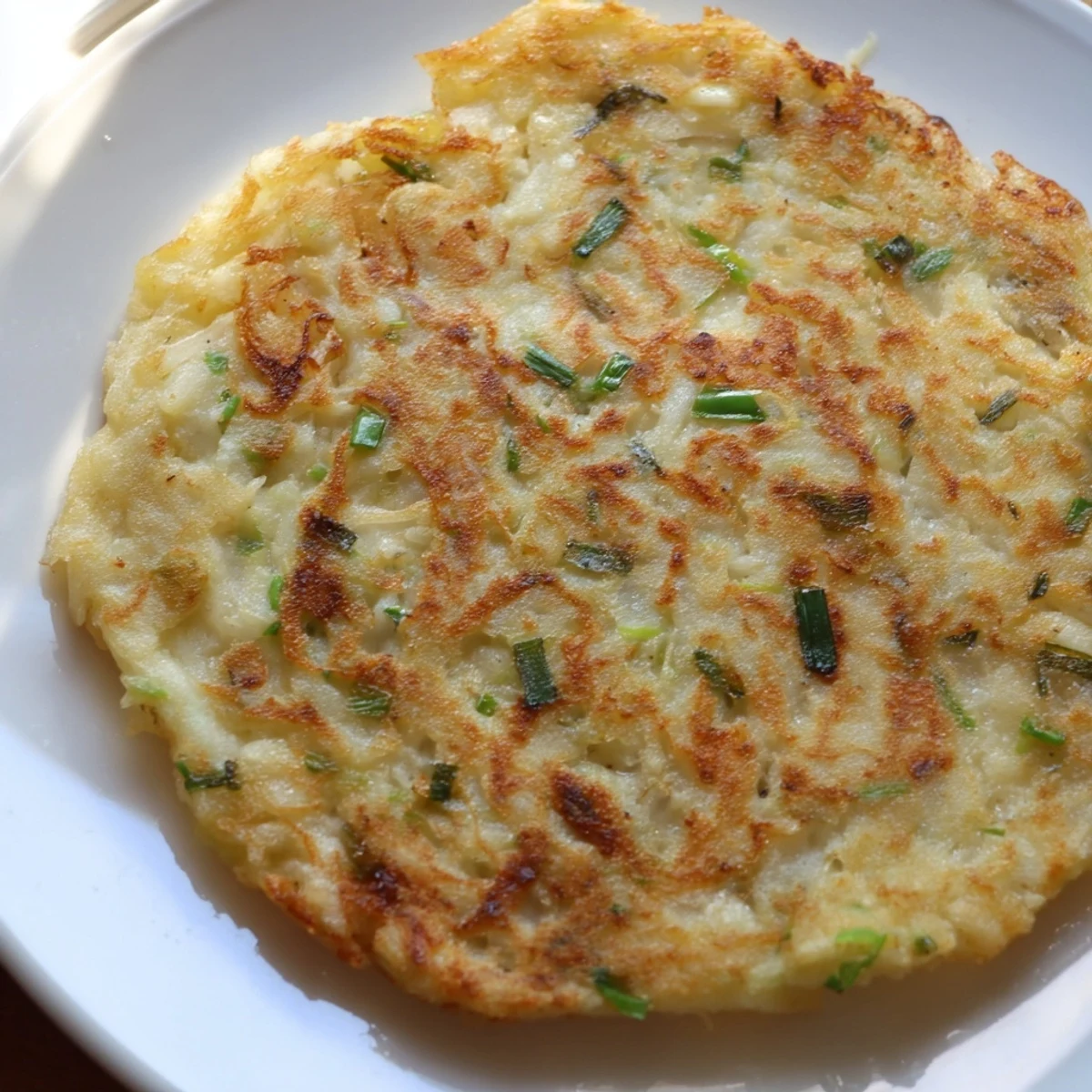 Thick Irish Boxty Potato Pancakes with Scallions stacked high on a wooden board, steam rising.
