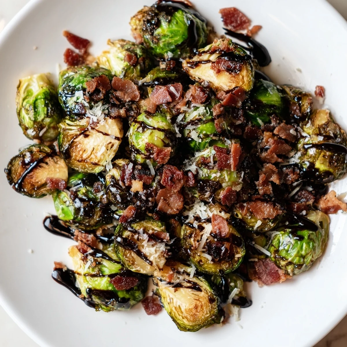 Roasted Brussels sprouts with savory beef bacon tossed together, topped with a drizzle of balsamic glaze on a rustic table.