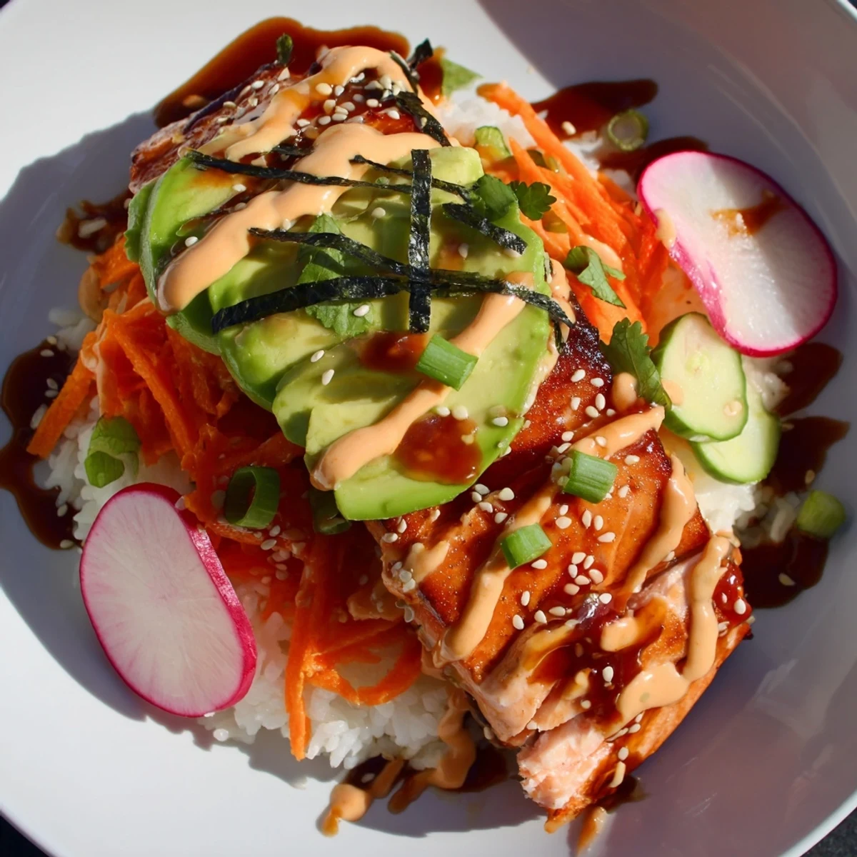 The Teriyaki Salmon Rice Taco Bowls dish features creamy avocado, fresh cilantro, and a spicy sriracha mayo drizzle.