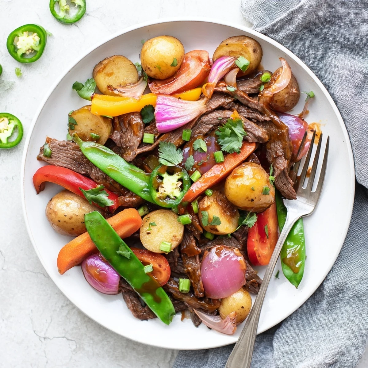 Flank steak and crisp bell peppers sizzle together in this Blackstone Cowboy Stir Fry Dinner recipe. 