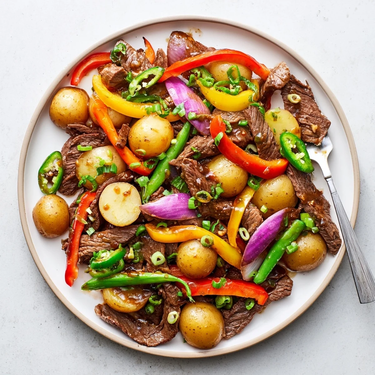 A rustic platter of Blackstone Cowboy Stir Fry Dinner featuring tender meat and vibrant, crunchy vegetables for dinner.