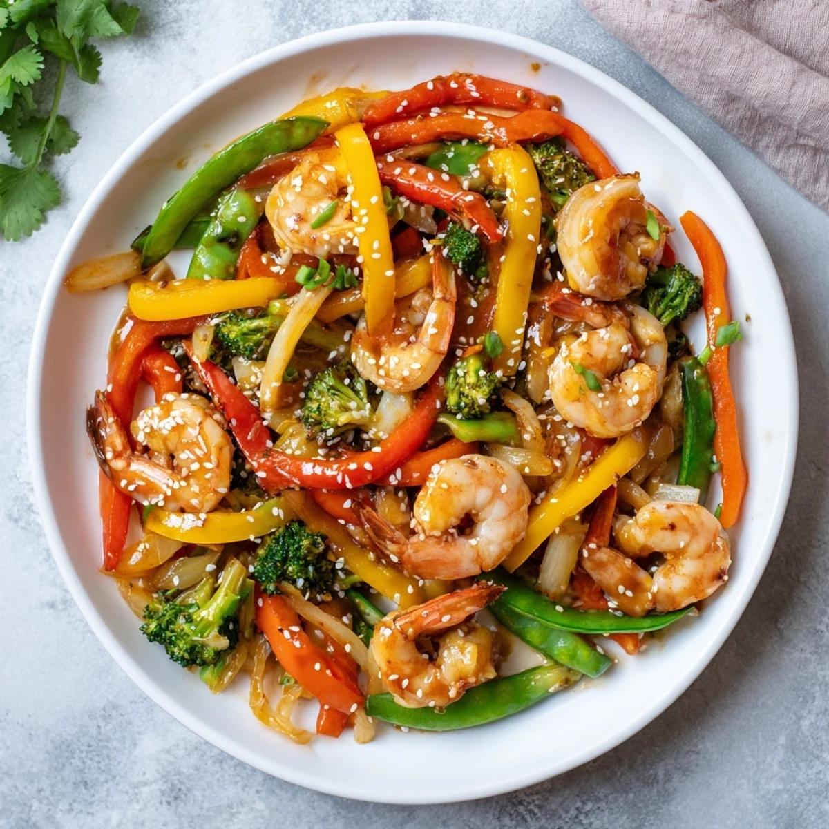 Steaming Shrimp Stir Fry served over white rice, garnished with green onions and sesame seeds.