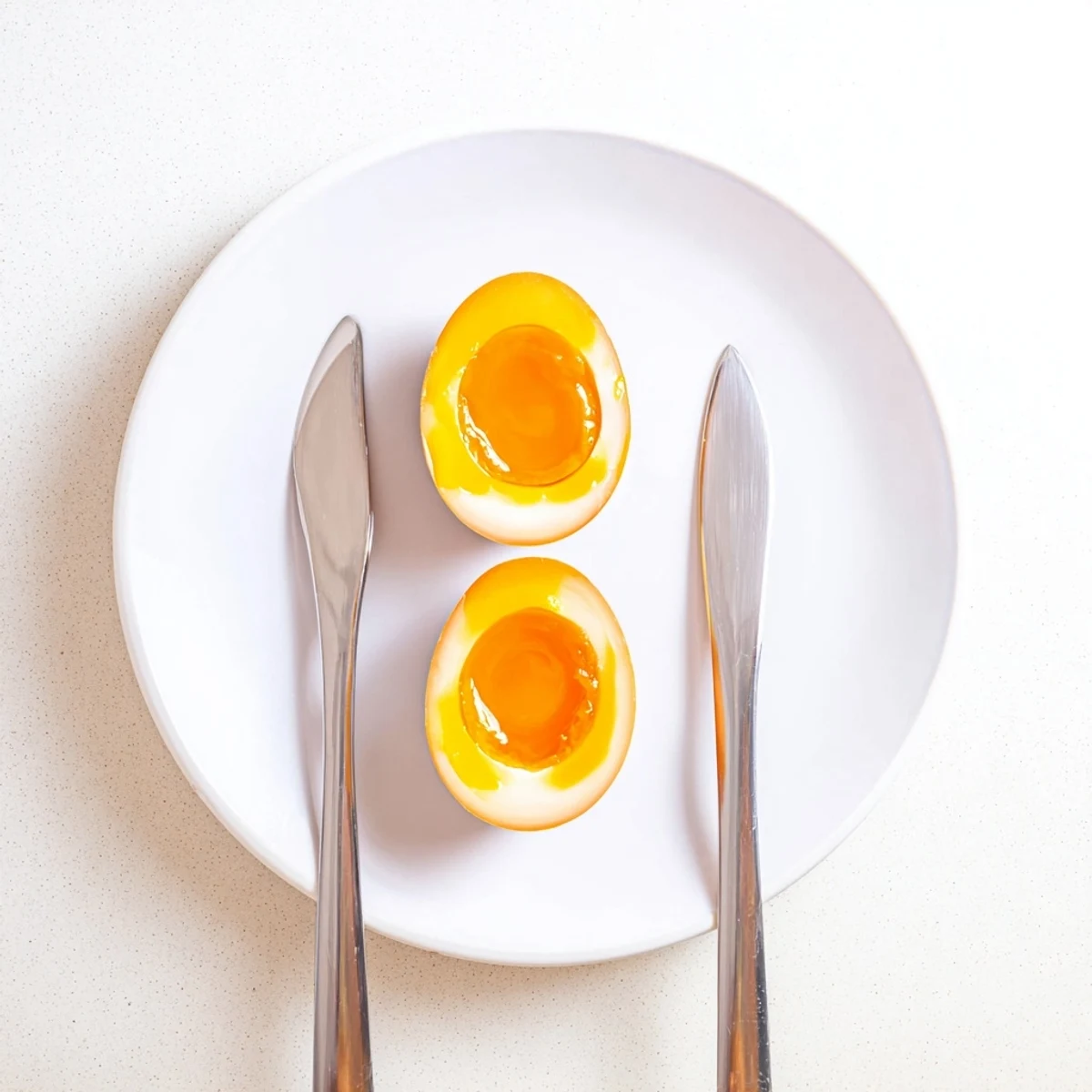 Perfectly marinated Ramen Eggs with a jammy yolk, glistening in savory soy sauce, ready for your next ramen bowl.