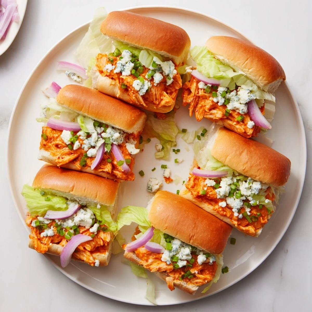 Easy Spicy Buffalo Chicken Sliders featuring soft buns, shredded Buffalo chicken, and blue cheese crumbles for a casual gathering.