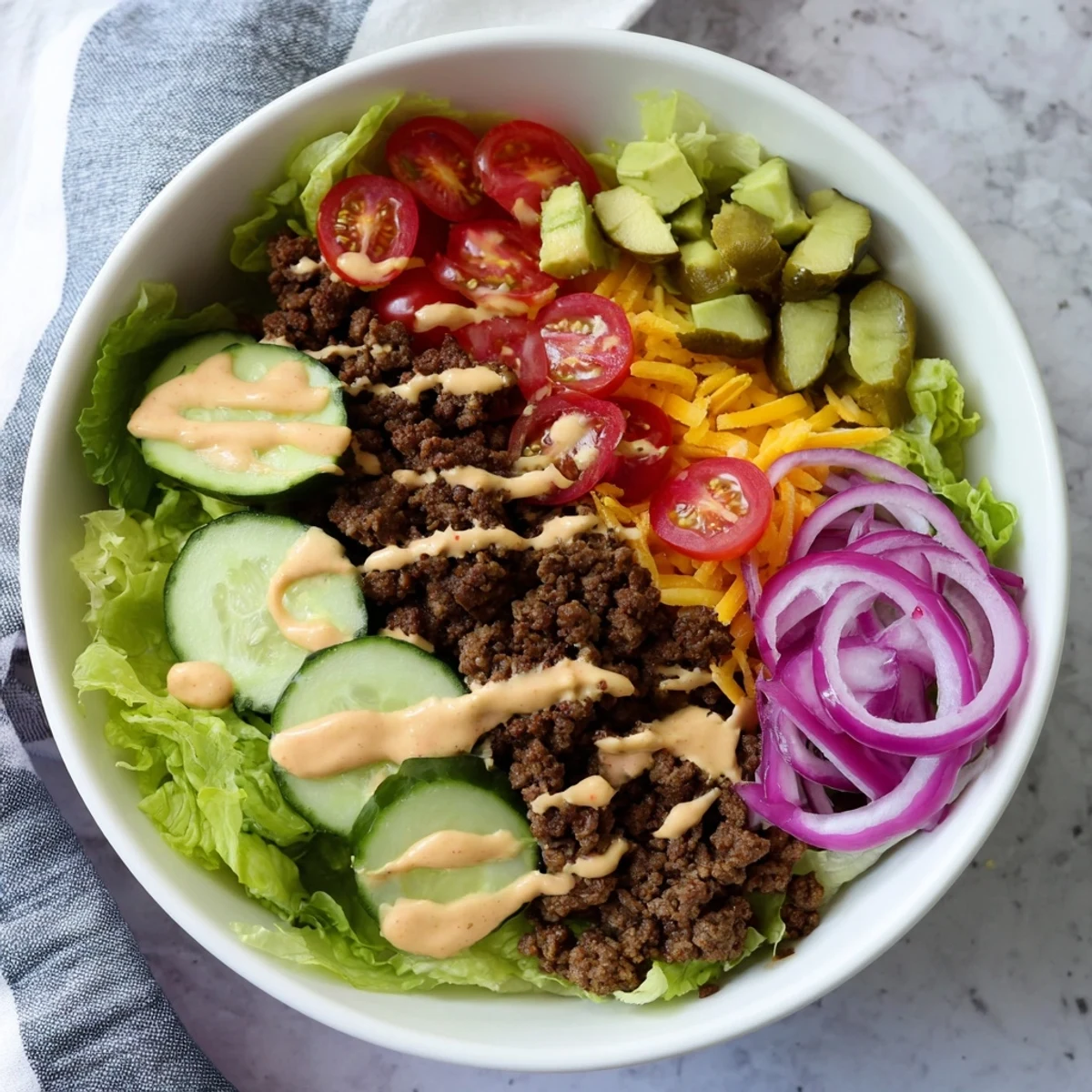 Serving suggestion of Burger Bowls with ground beef, cheese, and avocado in a bowl, ready for a low-carb dinner.