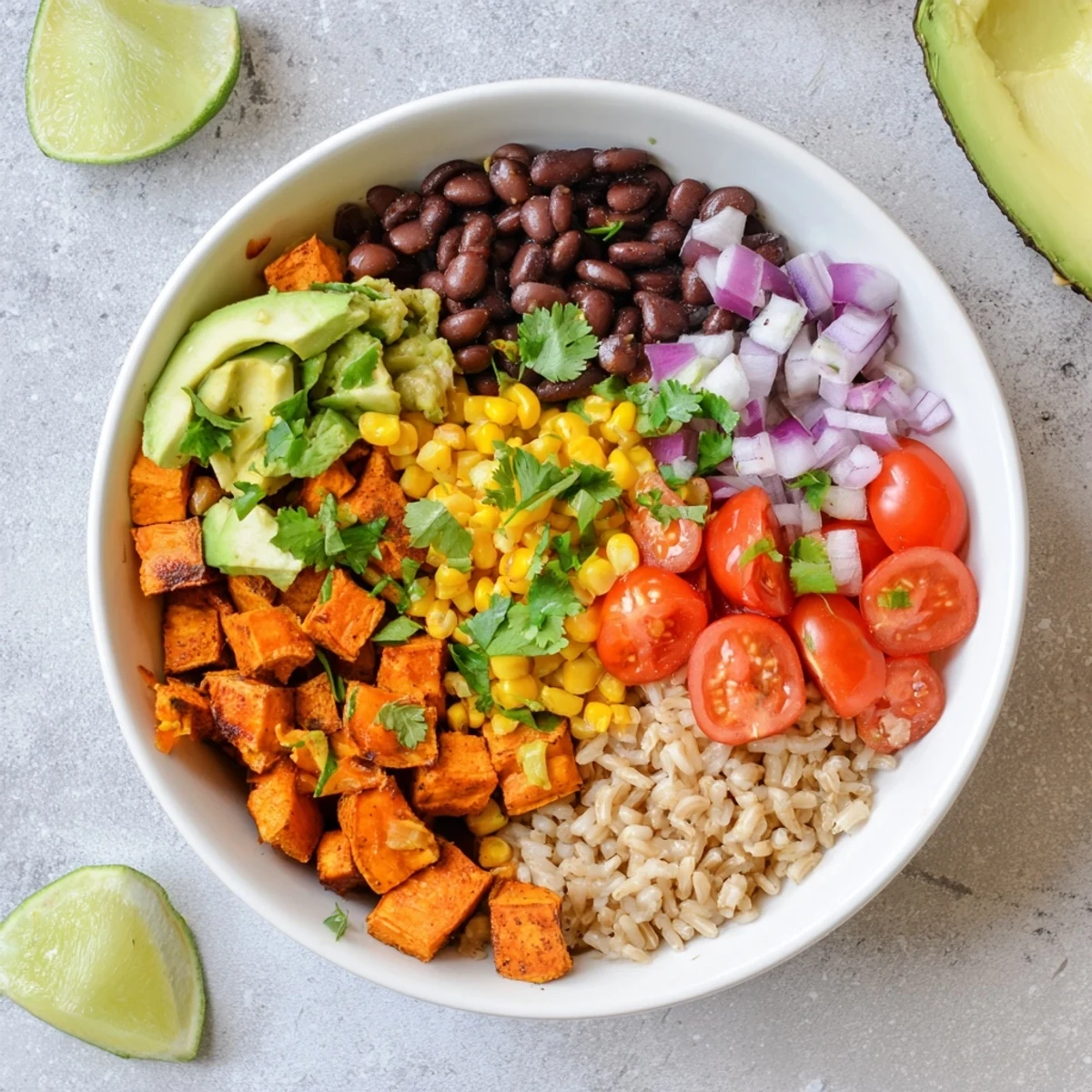 Hearty vegan sweet potato burrito bowl with fluffy rice spiced beans crisp vegetables