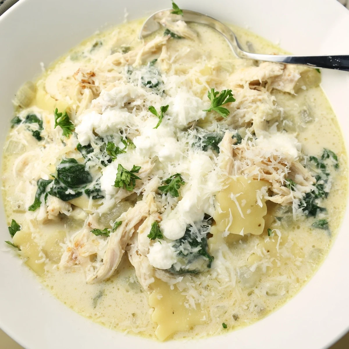 Comforting white lasagna soup featuring broken noodles and shredded chicken in a rich, creamy base