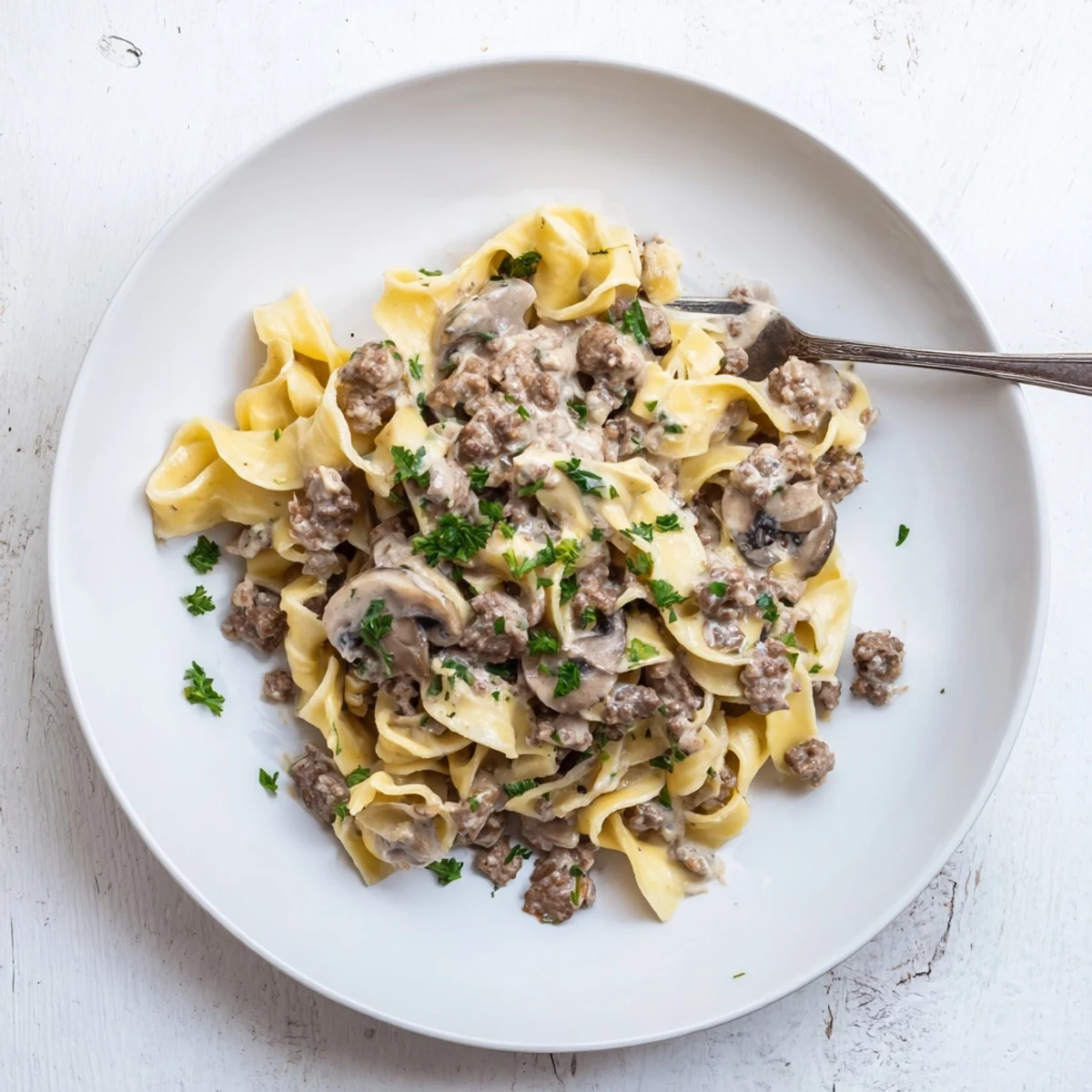 Hearty hamburger stroganoff bowl with savory mushroom sauce and garnished fresh parsley