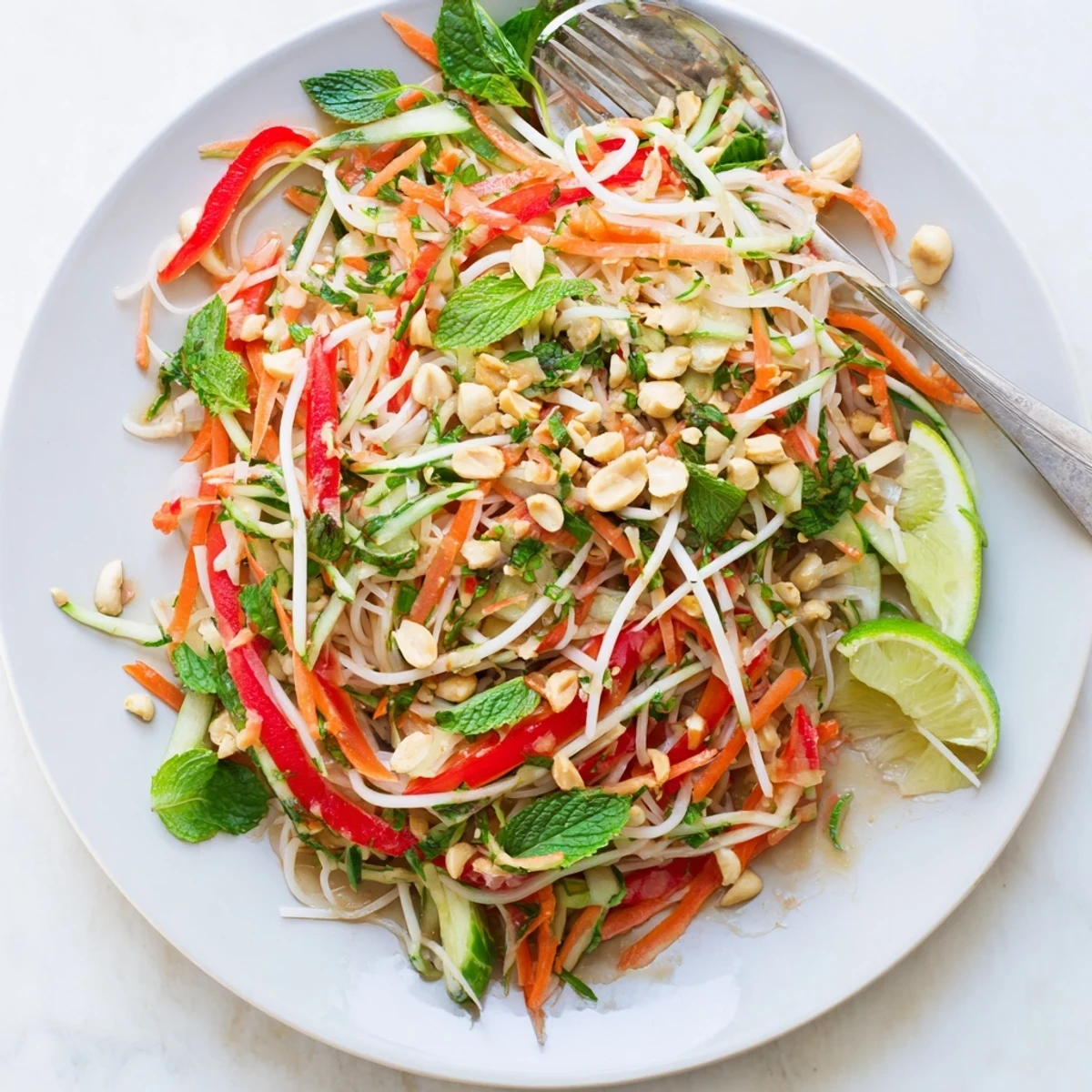 Fresh Vietnamese noodle salad with crunchy peanuts, bean sprouts, and zesty dressing drizzled over top