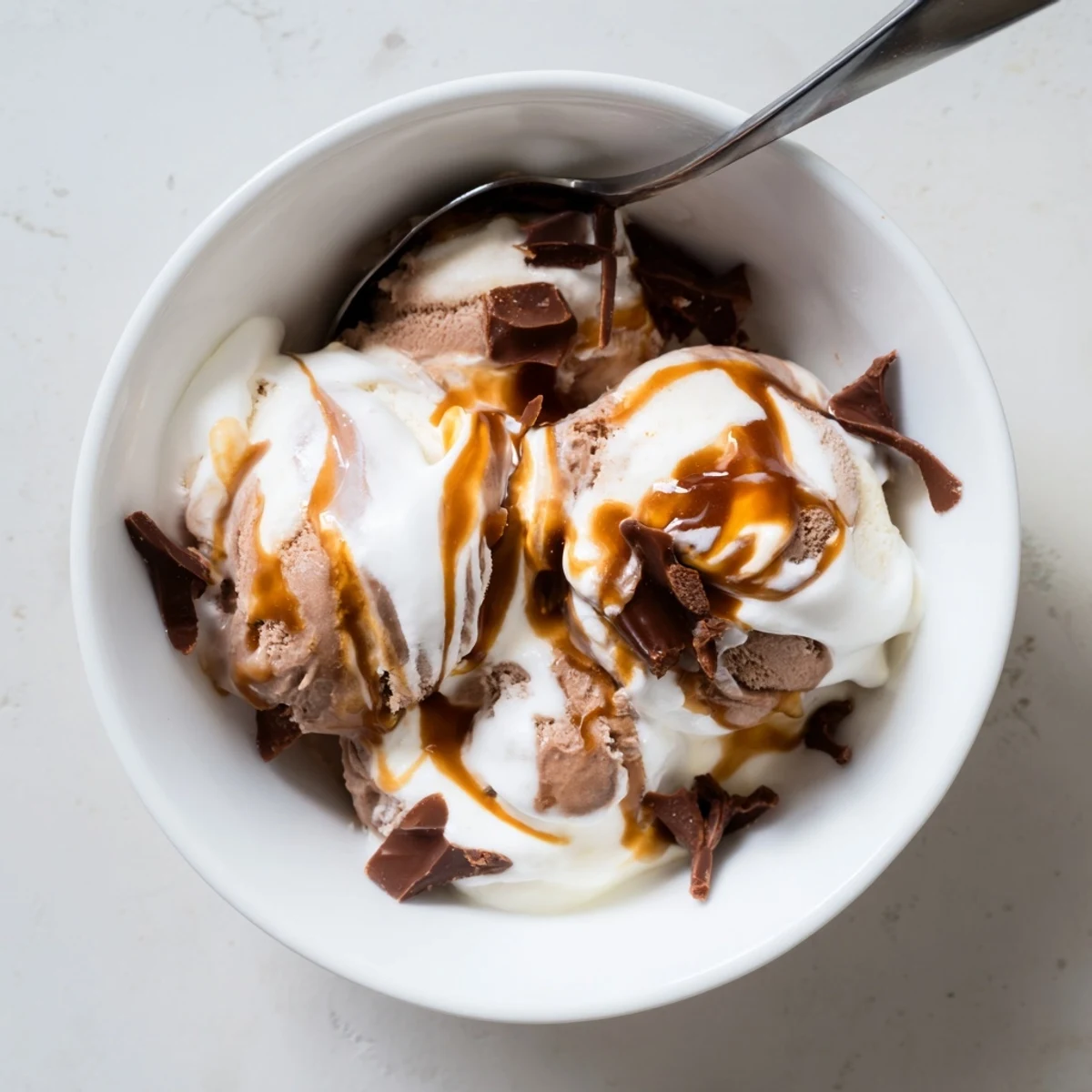 Creamy Ninja Creami Phish Food ice cream with marshmallow swirls and caramel ribbons in a bowl
