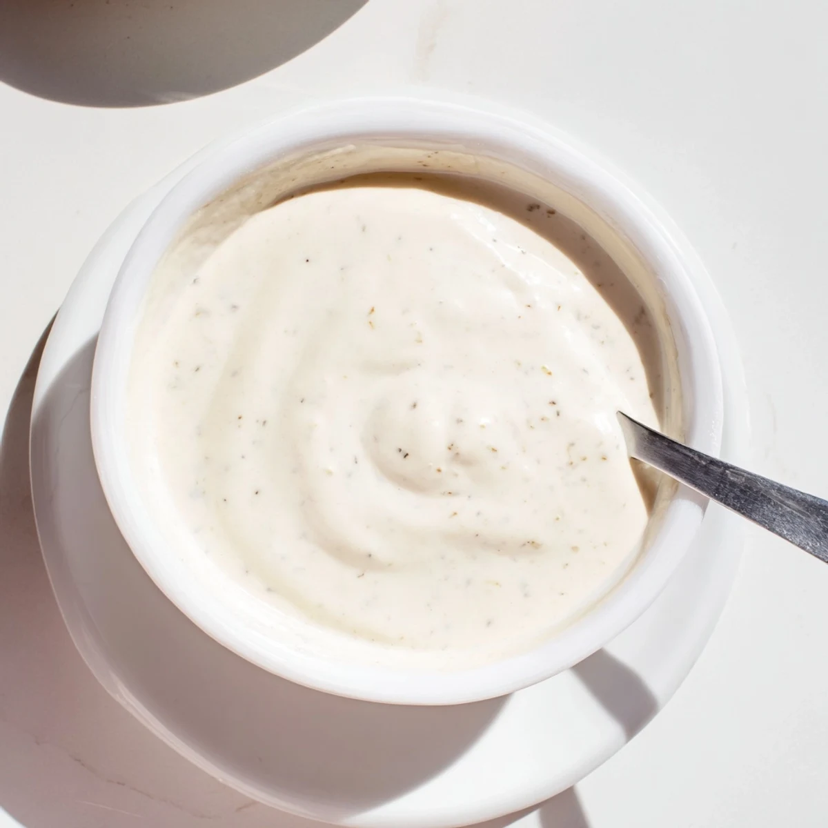 Creamy chicken shawarma garlic sauce drizzled over warm pita bread with fresh herbs