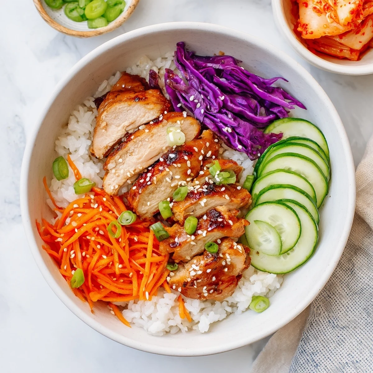 Weeknight dinner featuring Korean BBQ chicken bowls topped with sesame seeds and fresh veggies