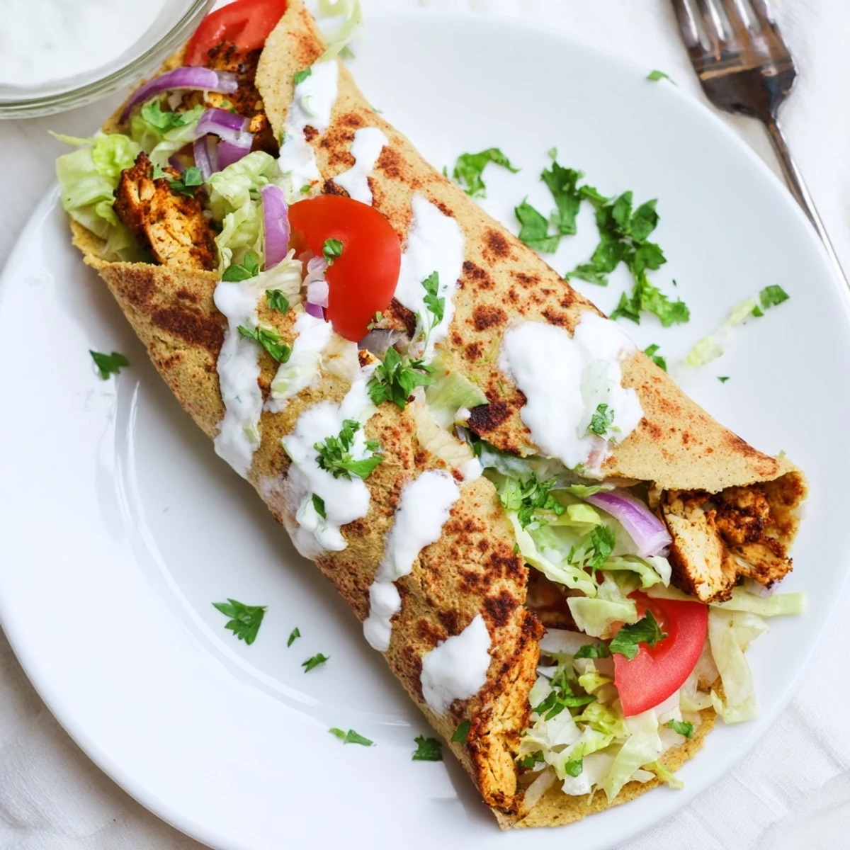 Protein-packed chicken wraps featuring cheesy baked flatbread layered with juicy meat and crisp vegetables