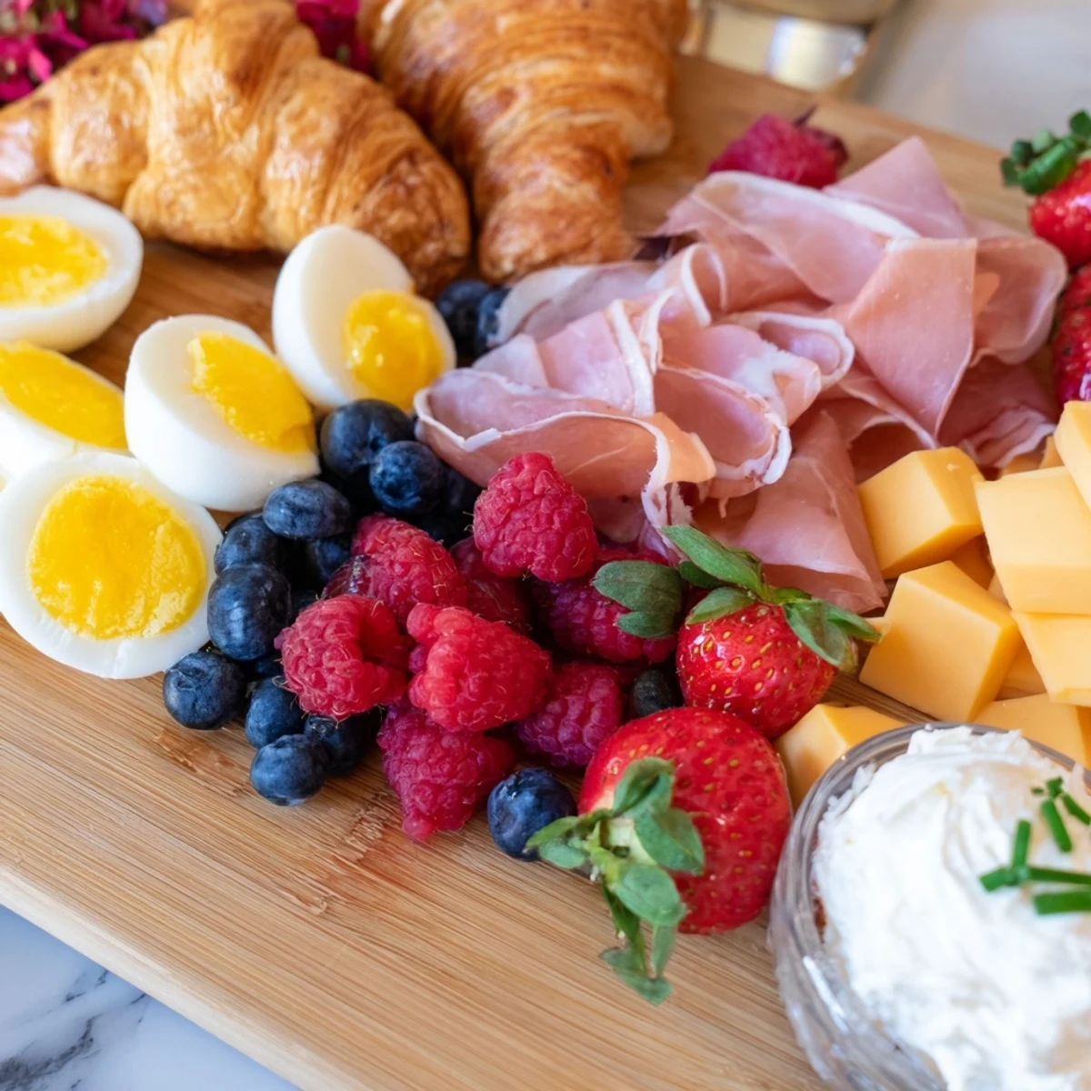 Breakfast charcuterie board featuring artisanal spreads crispy bacon and seasonal berries arranged for sharing