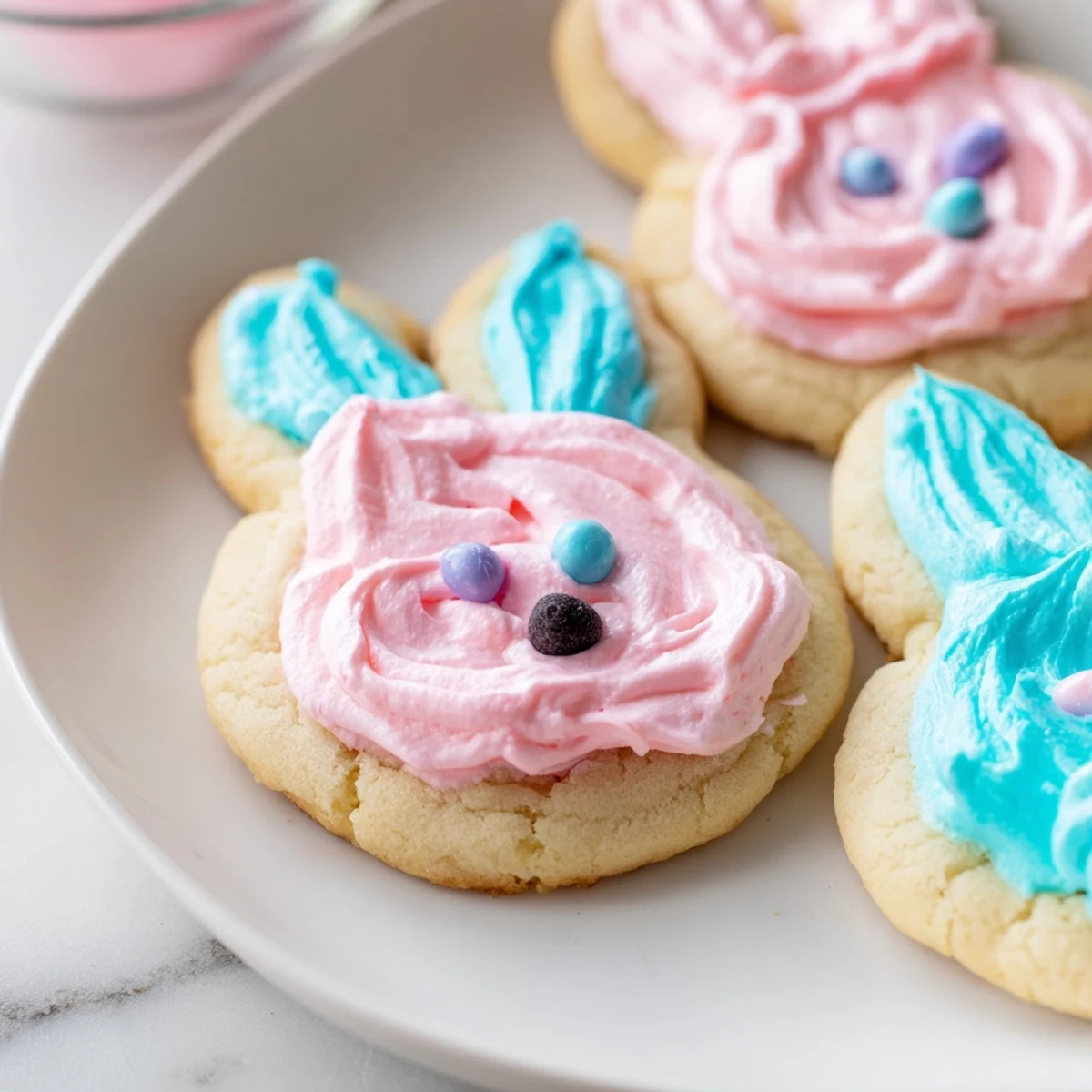 Adorable Buttercream Bunny Cookies with swirled pastel frosting on a rustic serving tray