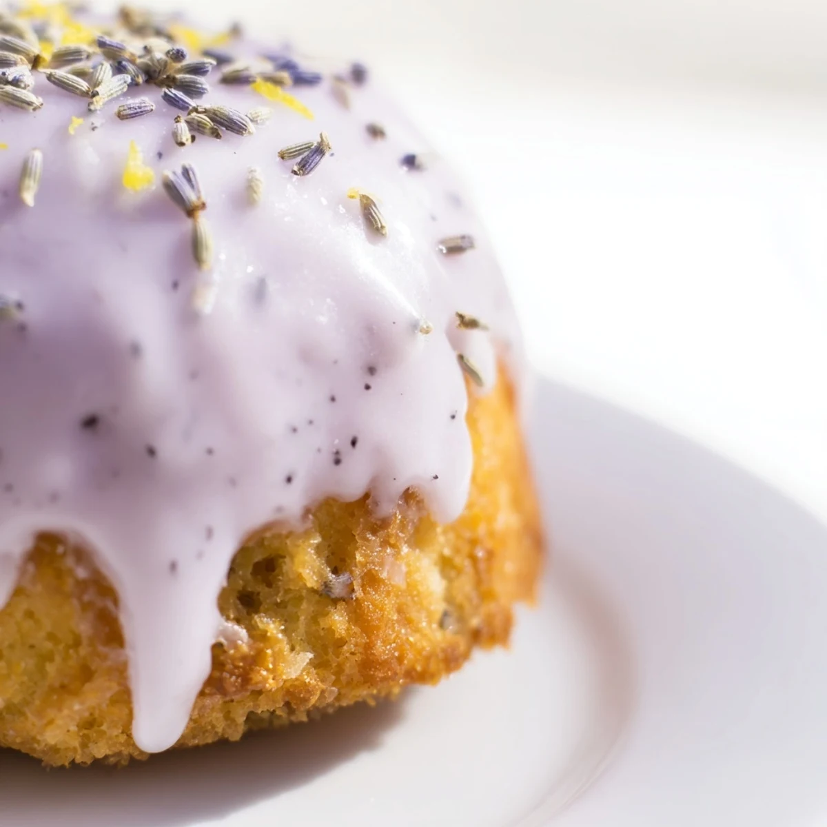 Golden mini lemon cakes with lavender glaze drizzled over tender, golden tops
