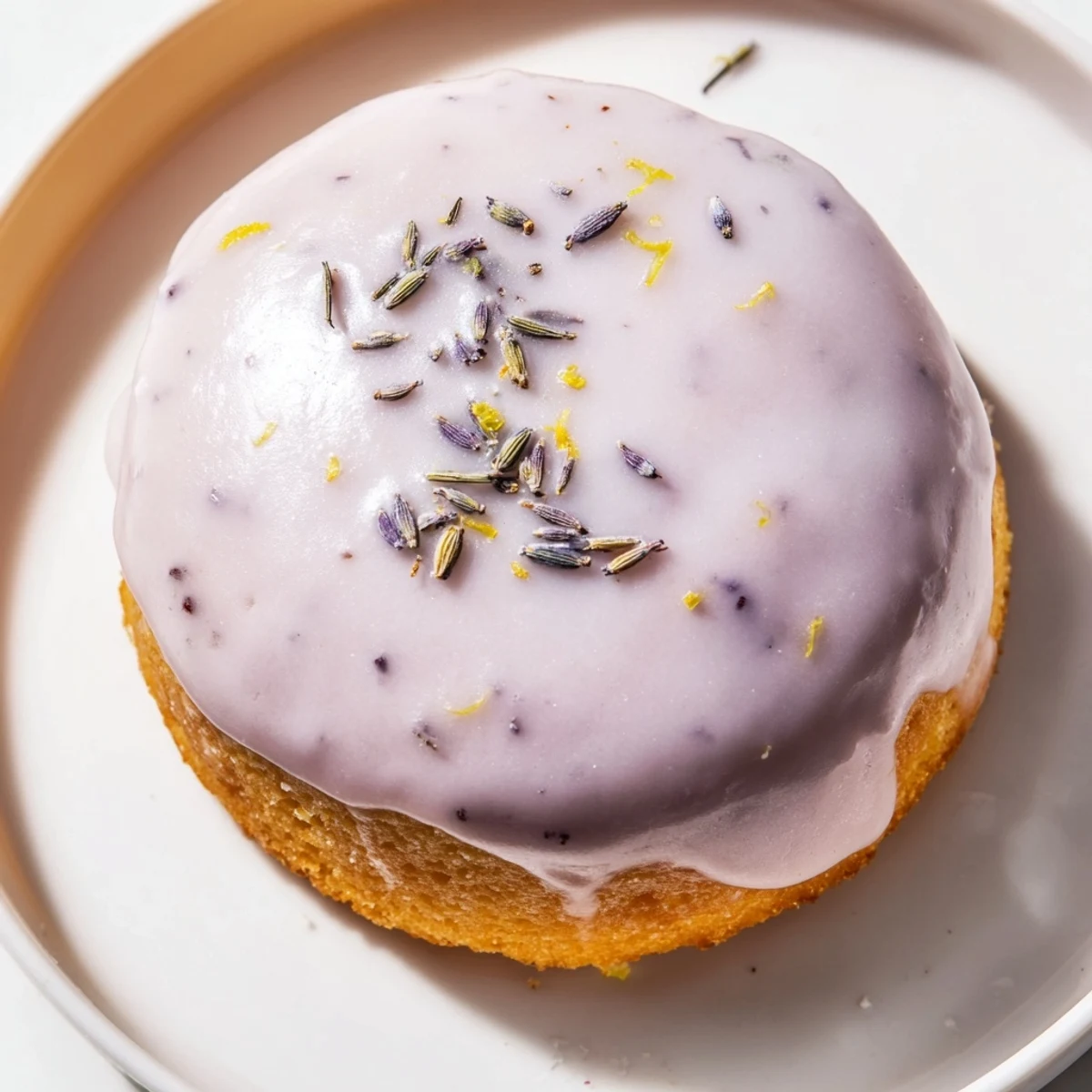 Mini lemon cakes with lavender glaze arranged on a tiered dessert stand