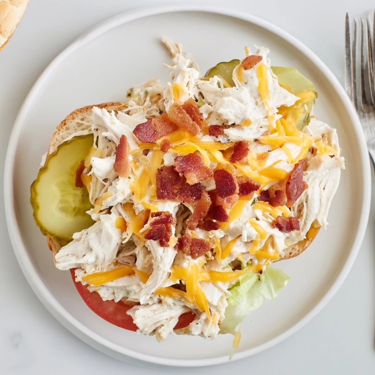 Creamy Crack Chicken Sandwiches with melted cheese, crumbled bacon, and jalapeño
