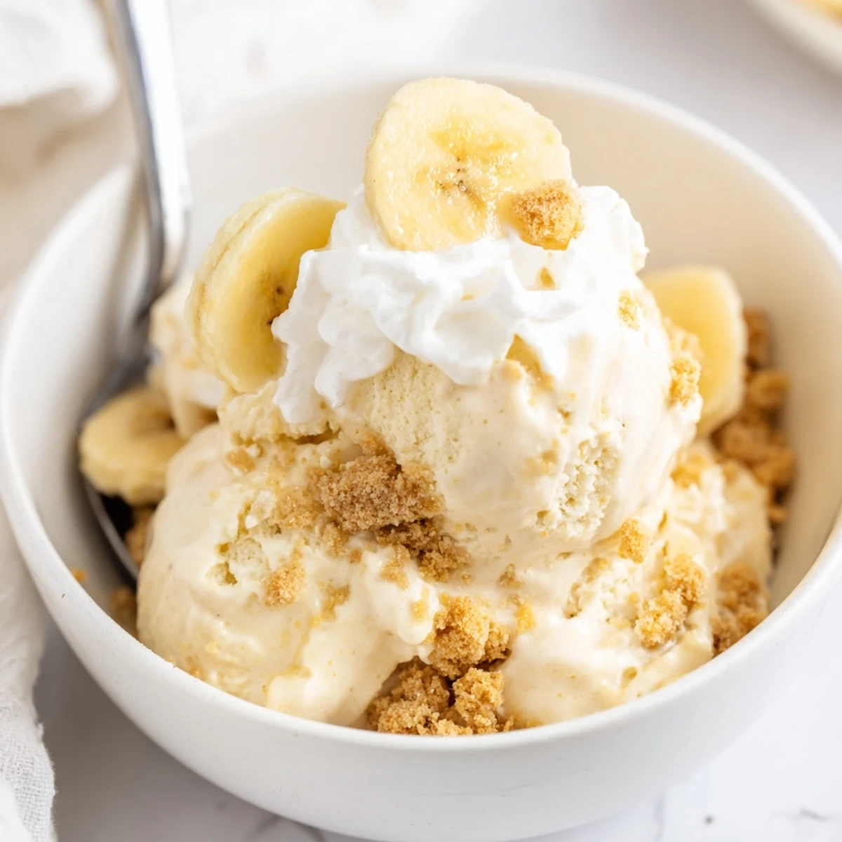 Chilled Ninja Creami Banana Cream Pie Ice Cream served with sliced bananas
