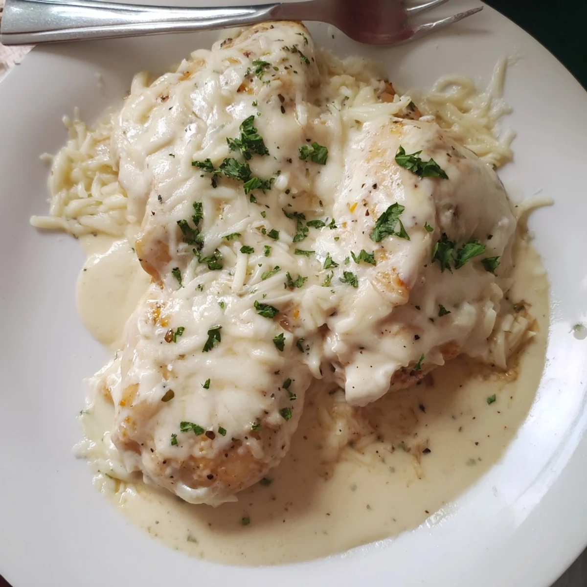 Baked Caesar Chicken With Creamy Parmesan Sauce, golden bubbly topping and parsley