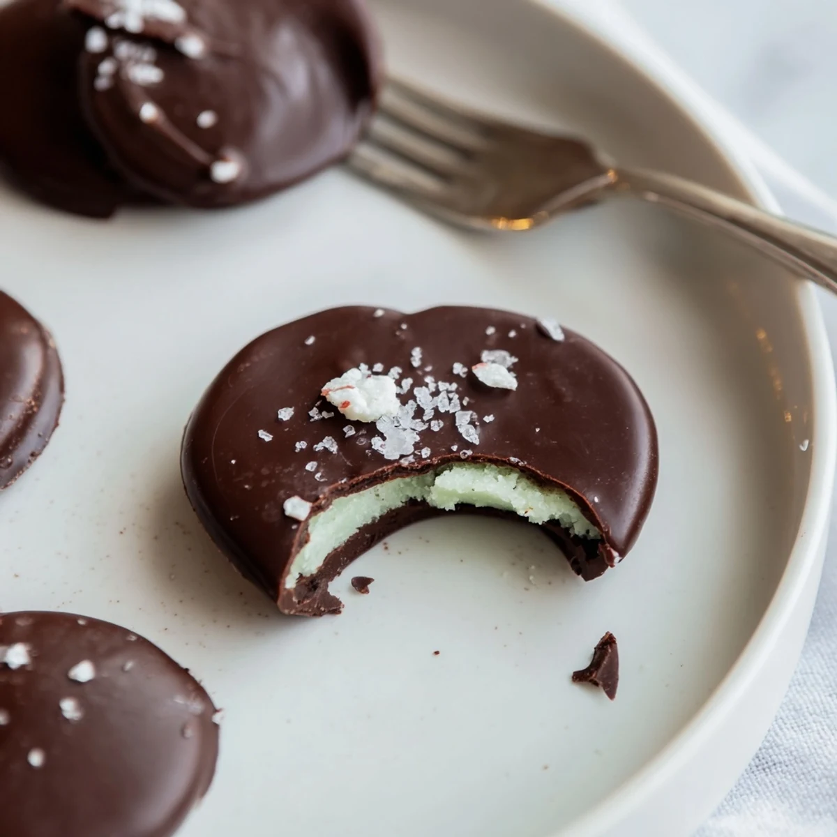 Homemade Peppermint Patties cooling on parchment, ready for holiday gifting