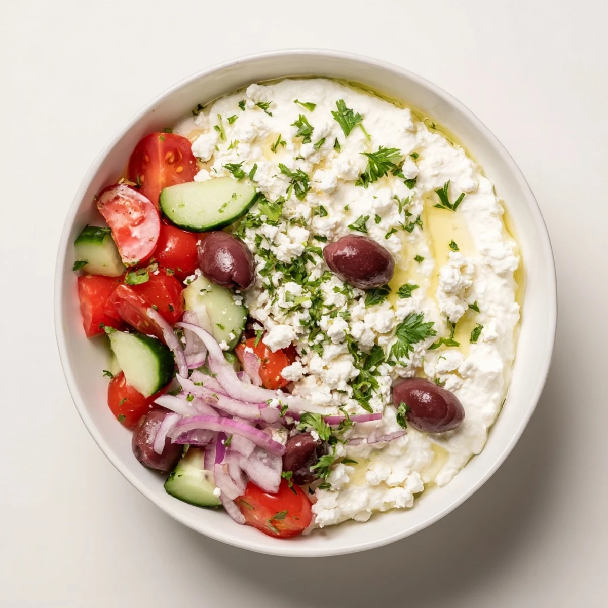 Refreshing cottage cheese bowl featuring crisp cucumbers, juicy tomatoes, and savory Mediterranean toppings