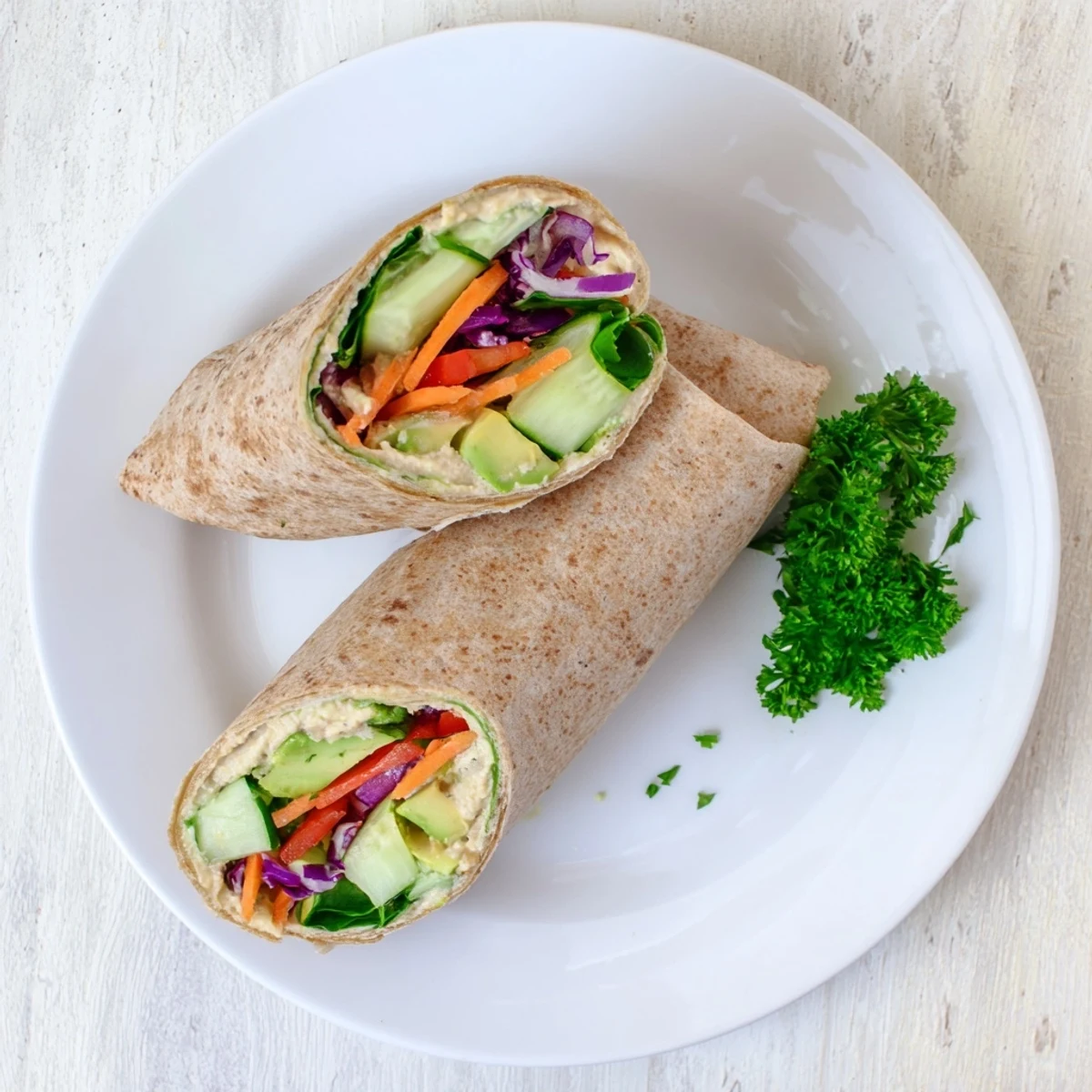Healthy lunch wrap stuffed with smooth hummus purple cabbage cucumber and avocado slices