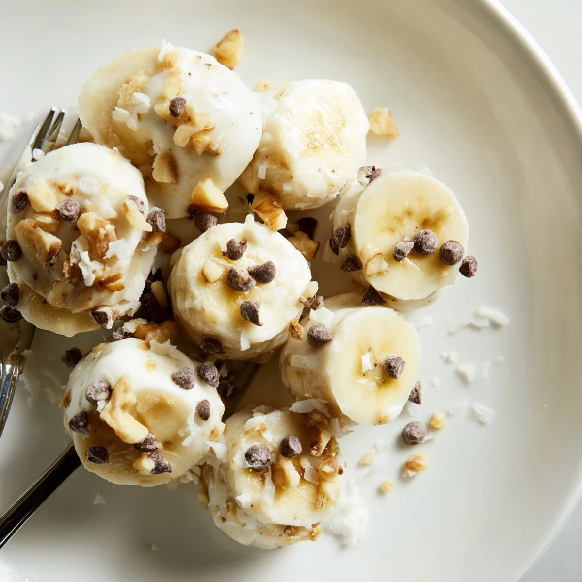 Homemade Frozen Banana Yogurt Bites cooling on baking sheet, waiting for snacking
