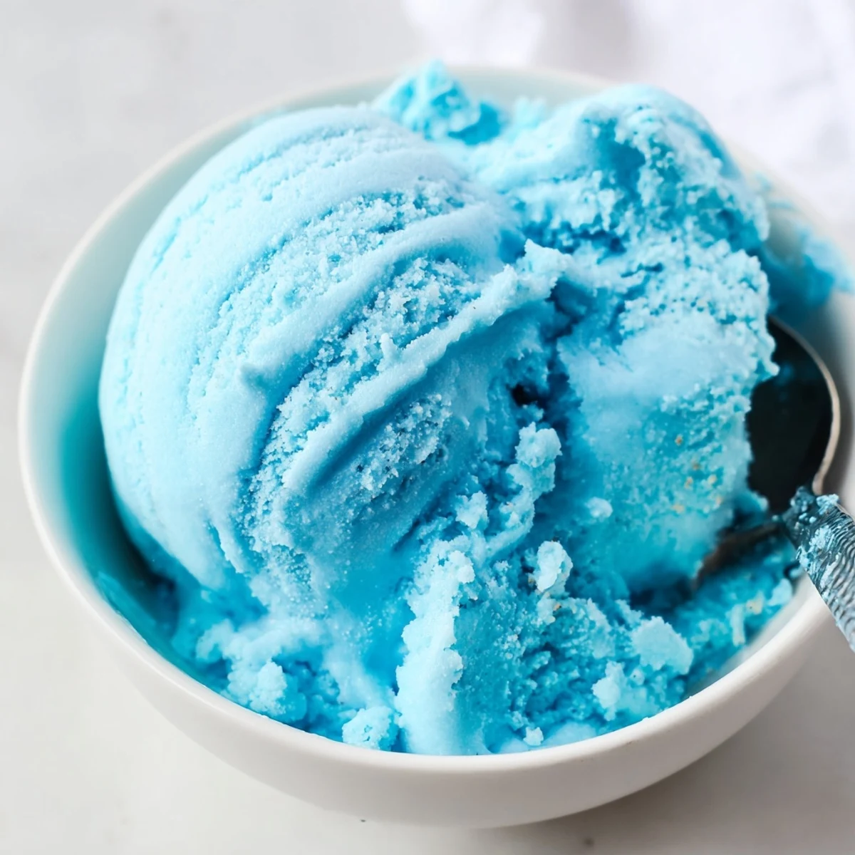 Bright blue moon ice cream churning in a frozen custard maker machine