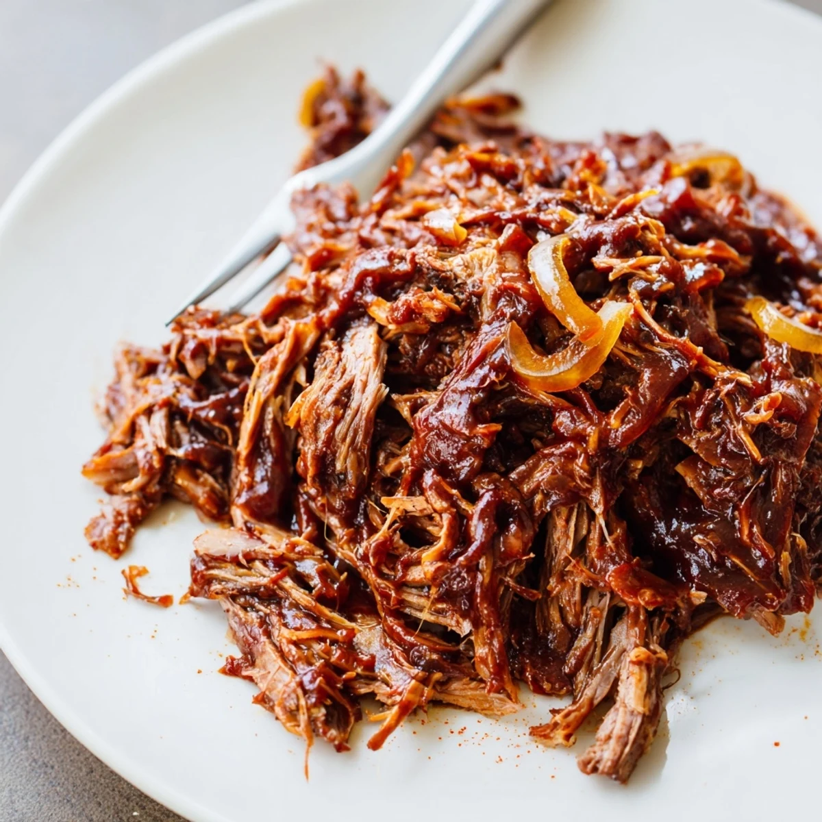 Slow Cooker BBQ Pulled Beef piled high on a toasted bun with creamy coleslaw