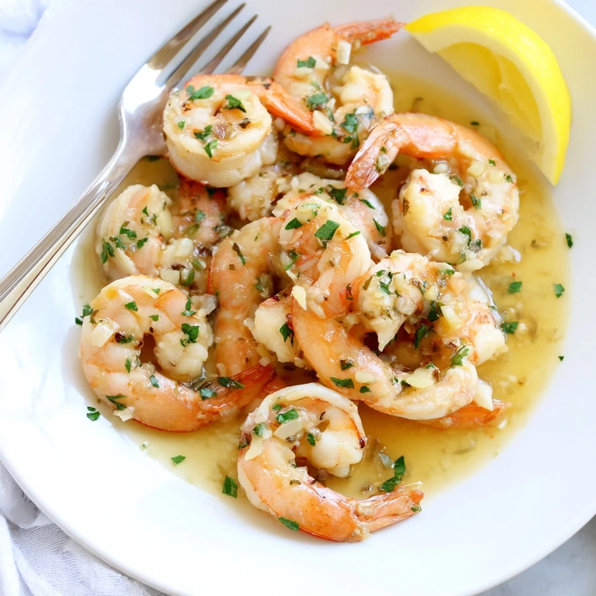 Golden buttered shrimp glistening in a garlicky lemon butter sauce with fresh parsley
